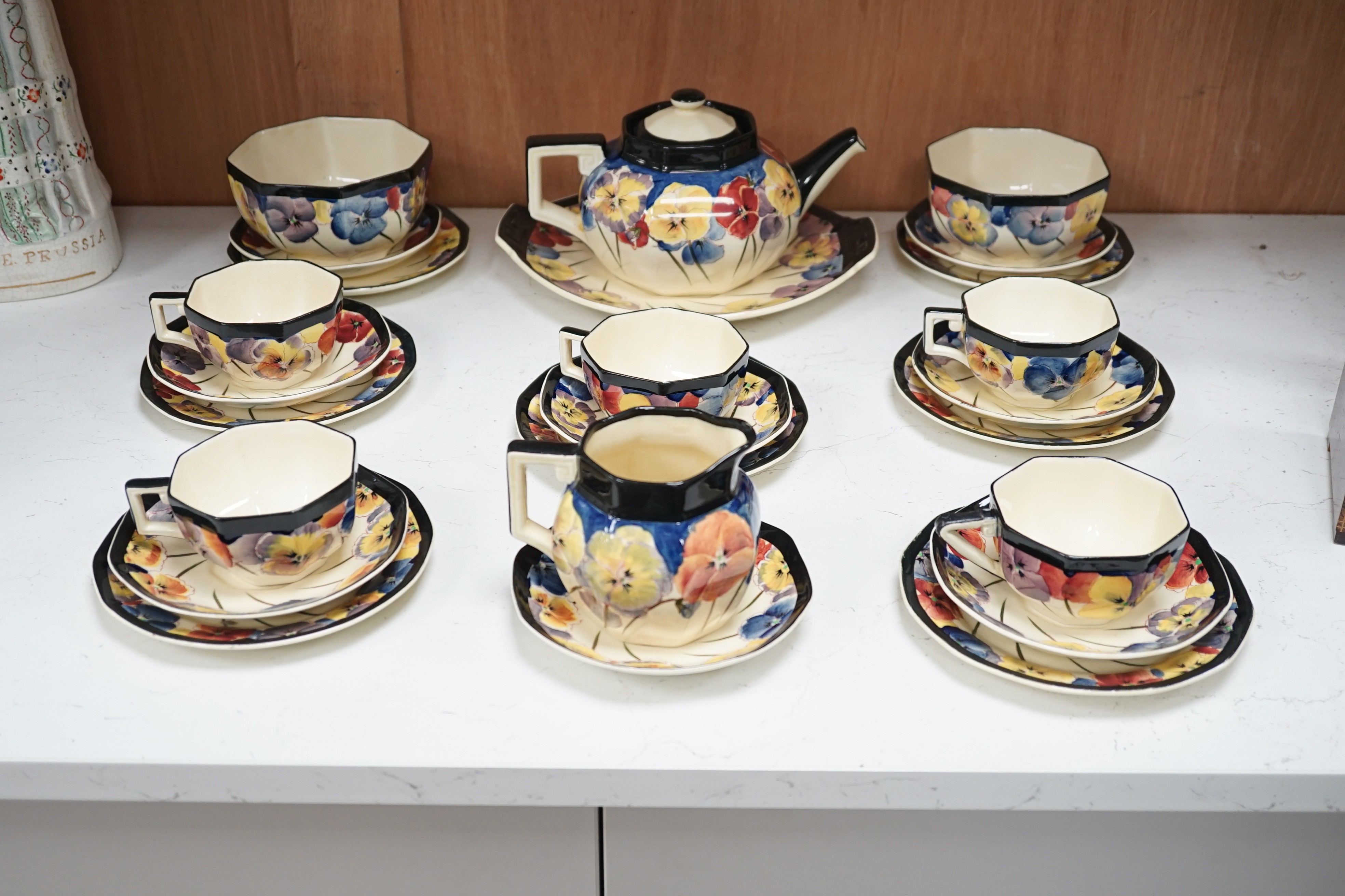 A Doulton “pansy” design tea set, marked on base D4049, Reg no:597783